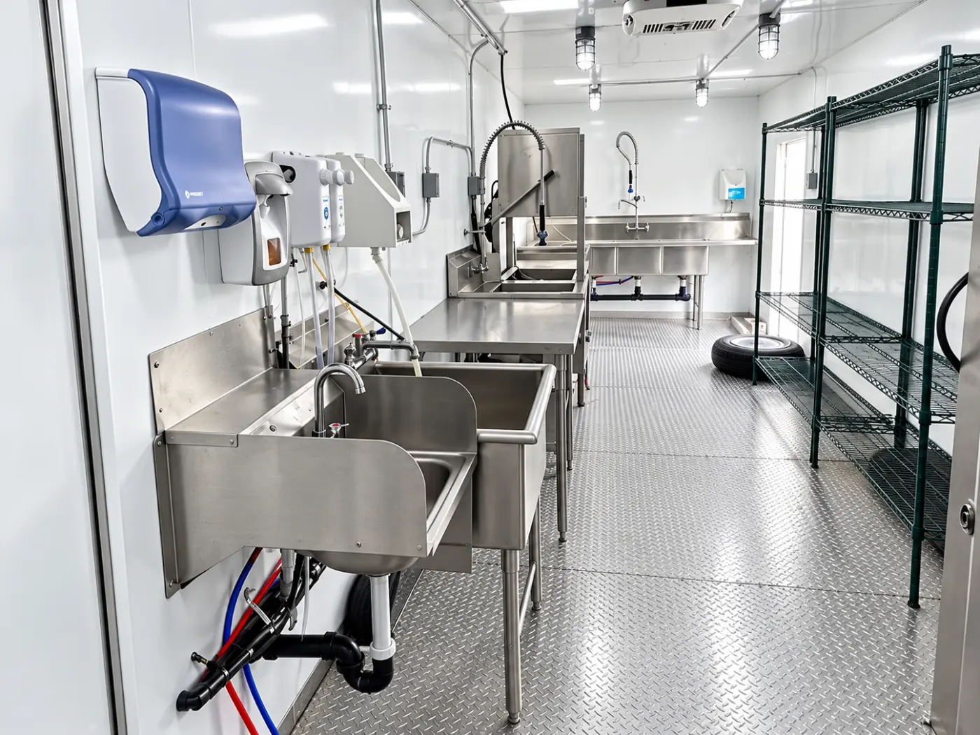 Handwashing station and storage racks in a dish trailer
