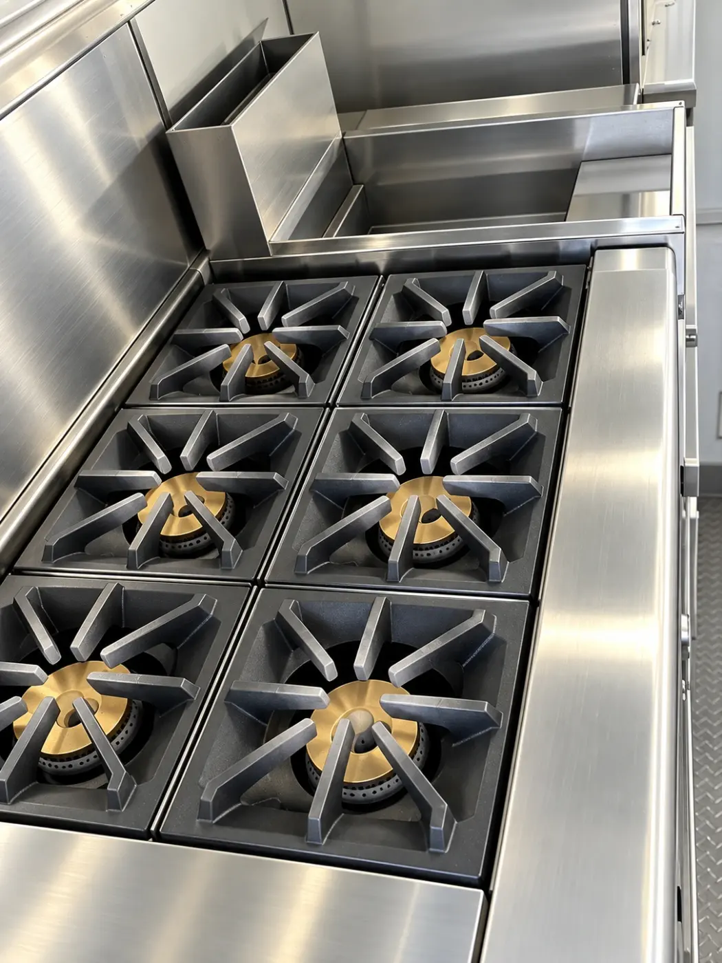Six-burner commercial gas range in a 24ft mobile kitchen