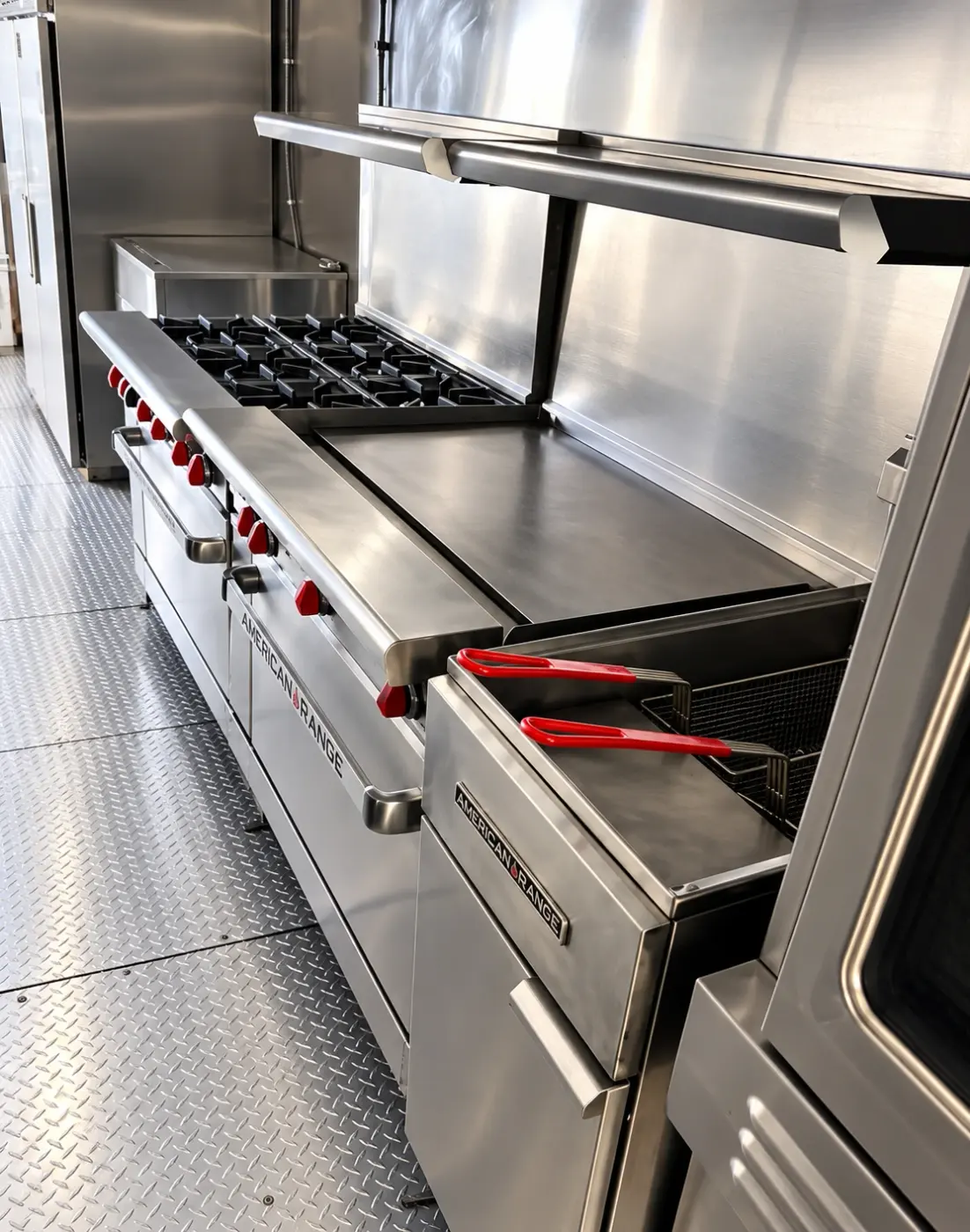 Range, griddle and fryer in a 38ft mobile kitchen trailer