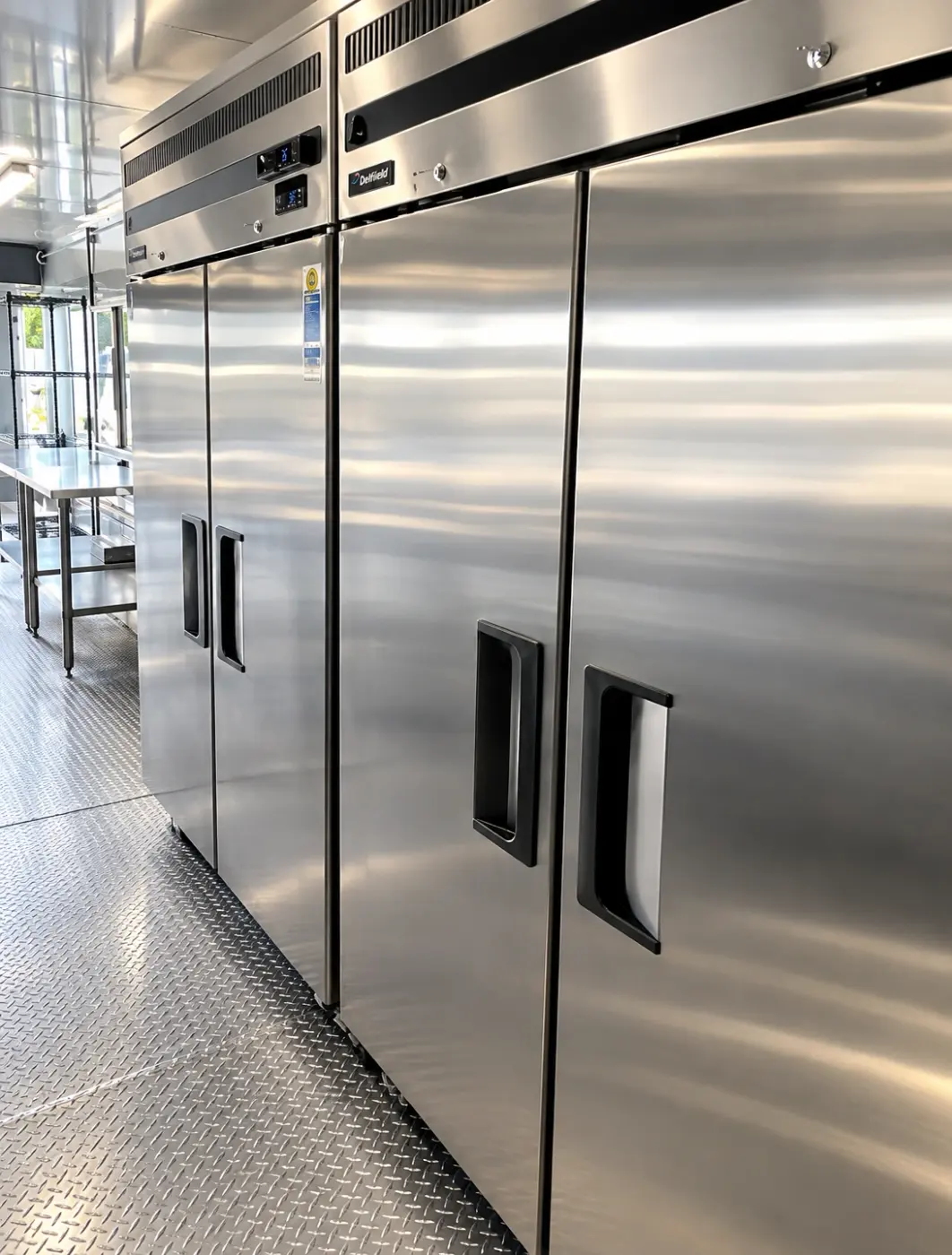 Reach-in refrigeration units inside a 40ft mobile commercial kitchen