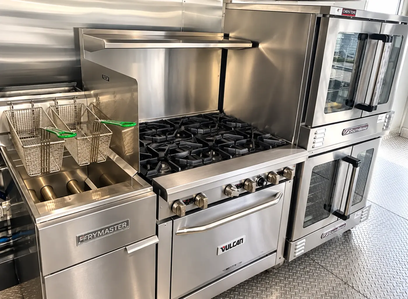 Deep fryer, gas range and double ovens in a 40ft bulk kitchen trailer