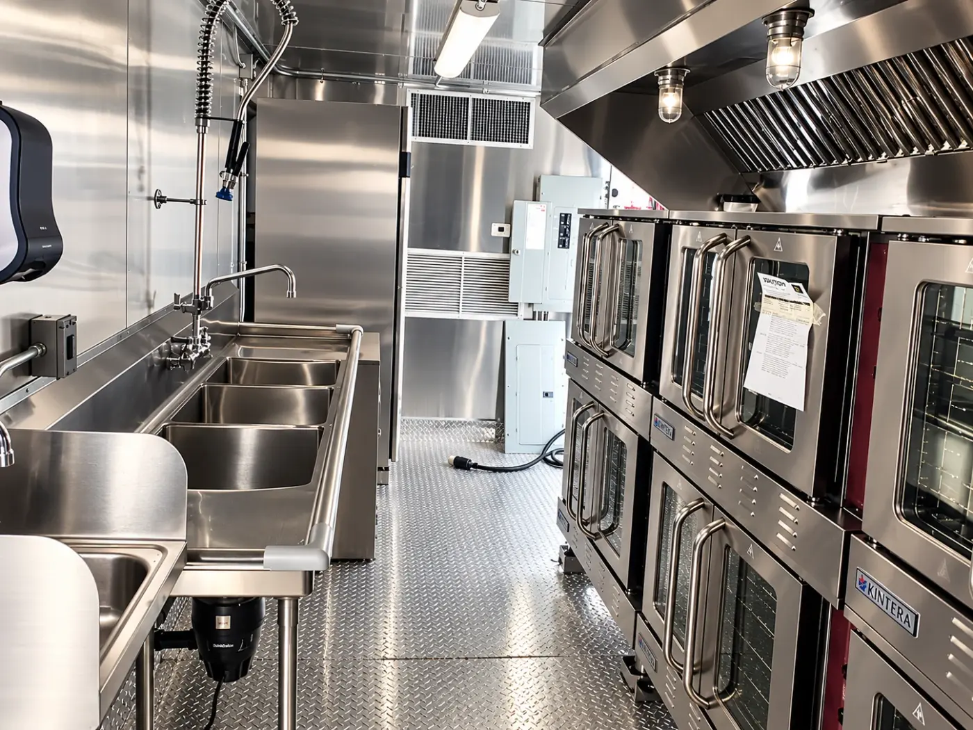 Sinks and convection ovens in a 40ft bulk combo kitchen trailer