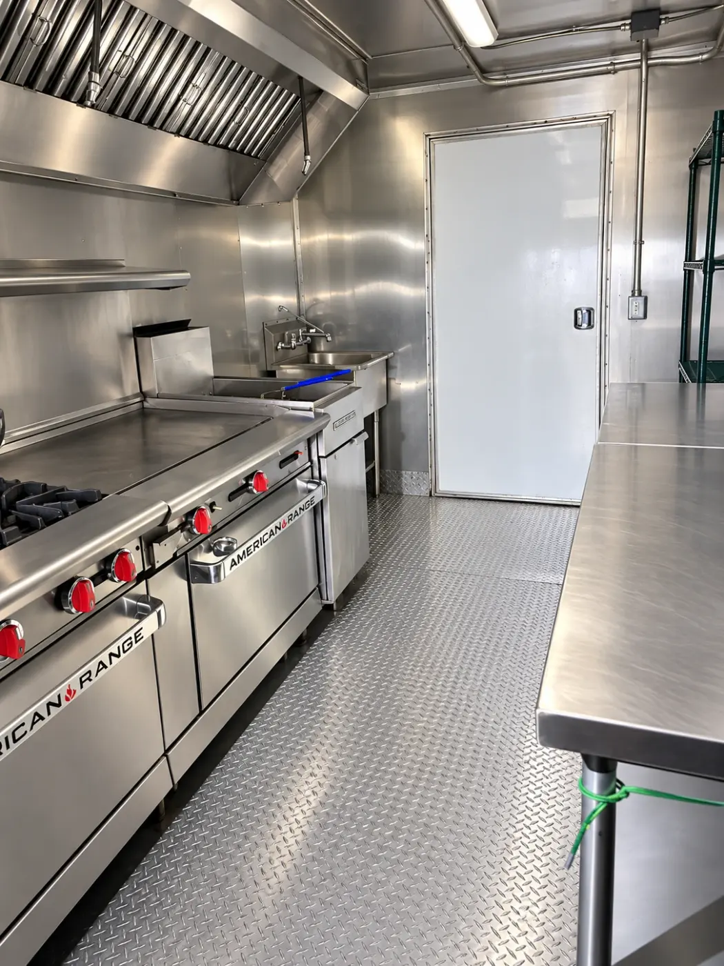 Range, griddle and work table in a 40ft mobile combo kitchen