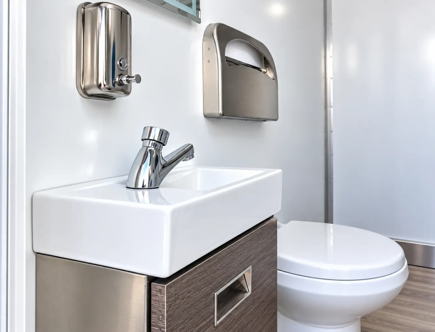 Sink and toilet inside a commercial restroom trailer