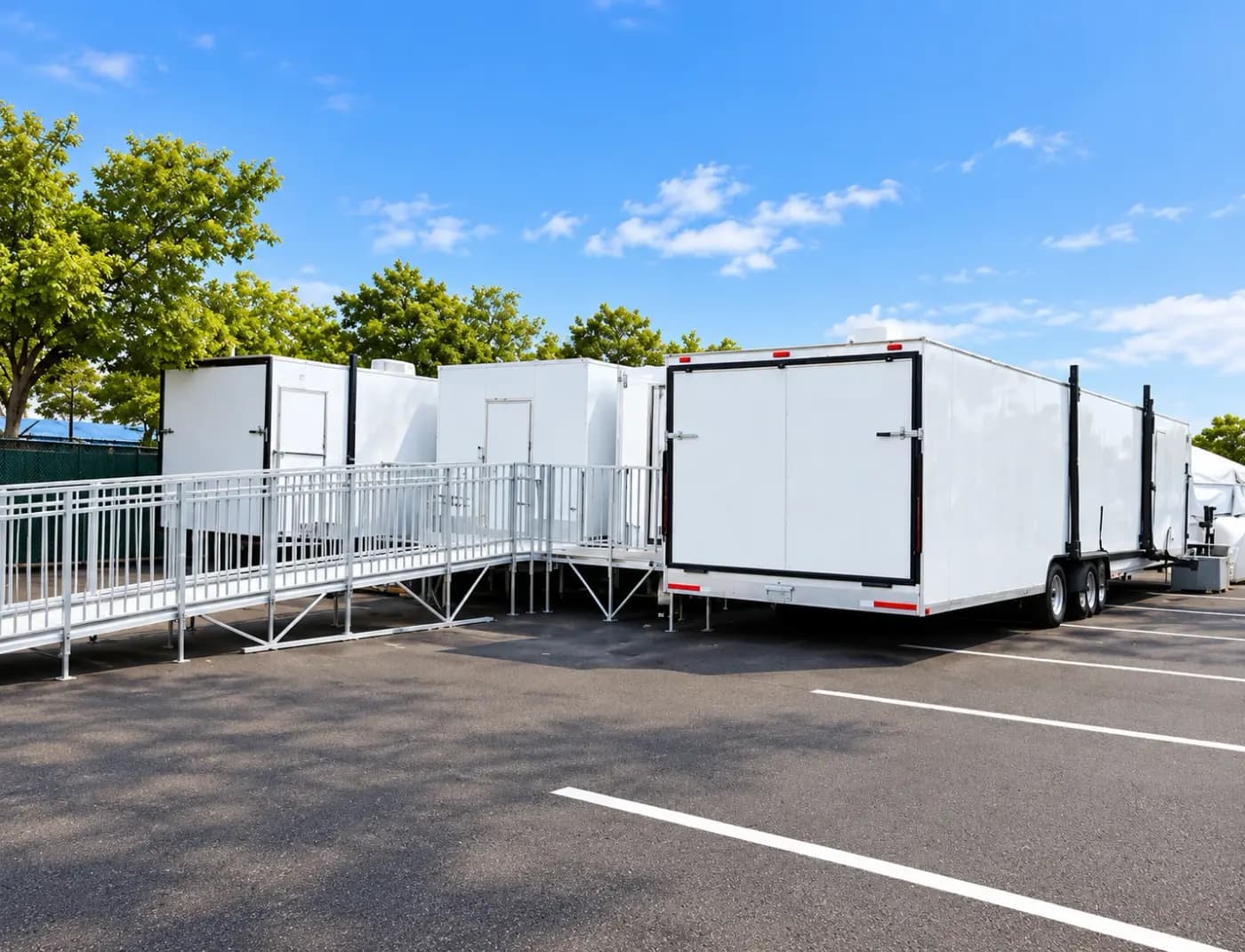 Aluminum ramps and rails connecting trailers on a paved lot
